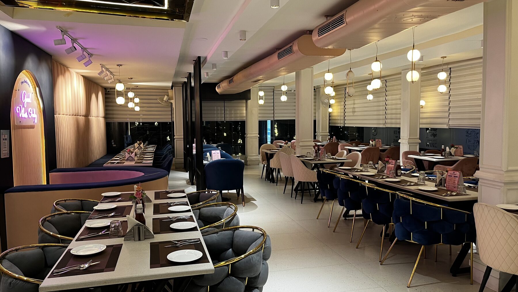 Long banquette seating and pendant lighting in the dining lounge at The Bellrocc, Patiala