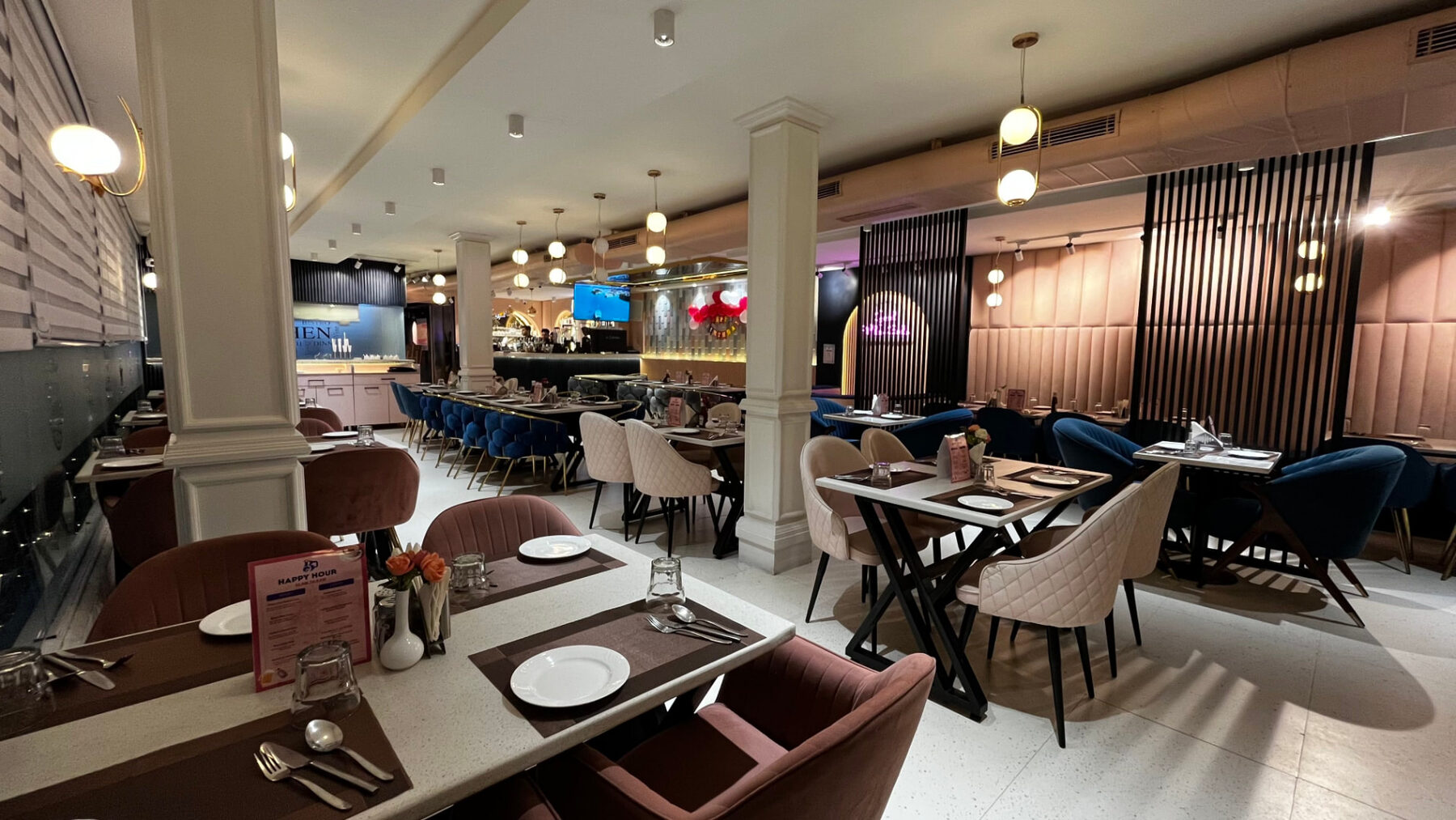 Main indoor dining hall with velvet chairs and marble tables at The Bellrocc, Patiala